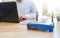 Closeup of a wireless router and a man using computer on living room at home ofiice, man working from home, while in quarantine