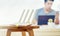 Closeup of a wireless router and a man using smartphone on living room at home ofiice, equipment for  working from home, while in