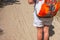 Closeup of woman with backpack on trailway in fir and pine trees forest. Concept of active lifestyle, hiking and tourism