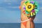 Closeup of woman in bikini holding pinwheel toy