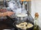 Closeup of a woman boiling fresh and tasty dumplings in the pot on the stove