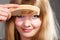 Closeup woman combing her fringe with comb