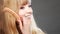 Closeup woman combing her hair with comb