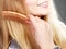 Closeup woman combing her hair with comb