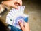 Closeup of a woman counting fifthy thousand pesos bills forming a range