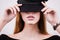 Closeup of woman covering her eyes with black fashionable cap. Fashion, fashion, cosmetics, lips.