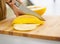 Closeup on woman cutting melon on slices