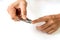 Closeup of a woman cutting nails, using nail clipper, health care concept