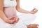 Closeup of woman doing meditative pregnancy yoga