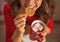 Closeup on woman drinking chocolate and eating christmas cookie