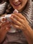 Closeup on woman eating marshmallow from cup of hot chocolate