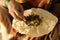 Closeup of woman eating South Indian north Karnataka peoples daily healhy breakfast Jowar roti or rotti or bhakri with dal curry