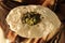 Closeup of woman eating South Indian north Karnataka peoples daily healhy breakfast Jowar roti or rotti or bhakri with dal curry