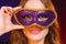 Closeup woman face with carnival violet mask on dark