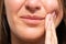 Closeup of woman face feeling tooth pain. Woman suffering from toothache, dental illness or oral diseases
