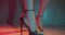 Closeup woman feet in high heels dancing in the studio with neon color light
