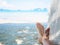 Closeup woman feet lying on hammock with trees and beautiful sea