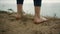 Closeup woman feet standing tophill. Unknown barefoot girl stop on dry grass.