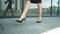 Closeup woman feet walking at street. Woman legs walking in high heel shoes