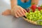 Closeup on woman with fruits plate eating grape