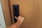 Closeup woman hand is holding door knob to opening a door in the hotel., Security system and access safety of electric door.,