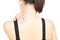 Closeup woman hand holding neck or shoulder with pain on white b