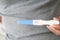 Closeup woman hand holding pregnancy test with happy moment, health care concept, selective focus