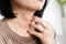 closeup woman hand scratching itchy skin on her neck caused by allergic to sweat