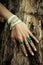 Closeup of woman hand on tree surface with lot of boho style je