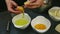 Closeup woman hands breaking up two raw eggs separate yolk from protein