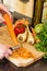 Closeup of woman hands cleaning the carrots