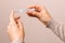 Closeup woman hands holding a glass thermometer with high temperature above thirty eight. coronavirus symptoms