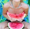 Closeup woman hands holding watermelon slice