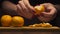 Closeup of woman hands purifies tangerine on wooden board in a modern kitchen. Healthy diet.