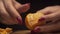 Closeup of woman hands purifies tangerine on wooden board in a modern kitchen. Healthy diet.