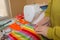 Closeup of woman hands sewing colored cloth outdoors