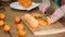 Closeup of woman hands slicing lime tangerine.