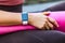 Closeup woman holding pink yoga mat, smartwatch on her hand with black empty display for time or pulse indicator