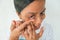 Closeup of a woman inserting a contact lens in her eye