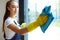 Closeup woman janitor hands holding blue rag for cleaning