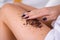 closeup woman legs with coffee massage scrub. Cosmetology, grooming, Spa cosmetic products, beauty and bikini concept