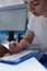 Closeup of woman patient signing medical questionnaire