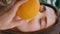 Closeup woman picking orange lush farmland. Vertical happy lady sniffing citrus