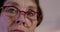 Closeup of woman portrait 60 yo with glasses. Vision problems in older age.