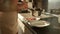 Closeup of woman pouring hot soup in bowls with ladle. Domestic food, cooking at home, housewife working.