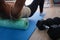 Closeup of woman riding cork massage roller to relieve tension in back muscles