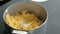 Closeup woman`s hand making mashed potato, adding butter and salt and mix. Cooking mashed potatoes.