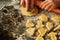 Closeup of woman`s hands working with dough and making biscuits