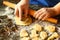 Closeup of woman`s hands working with dough and making biscuits