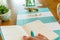 Closeup of woman`s manicured hand holding turquoise colored pen writing in date book